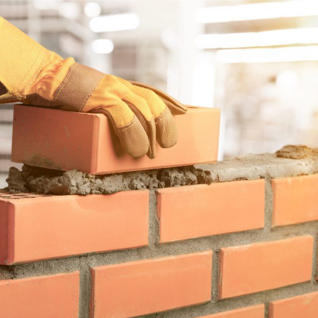 Industrial,bricklayer,installing,bricks